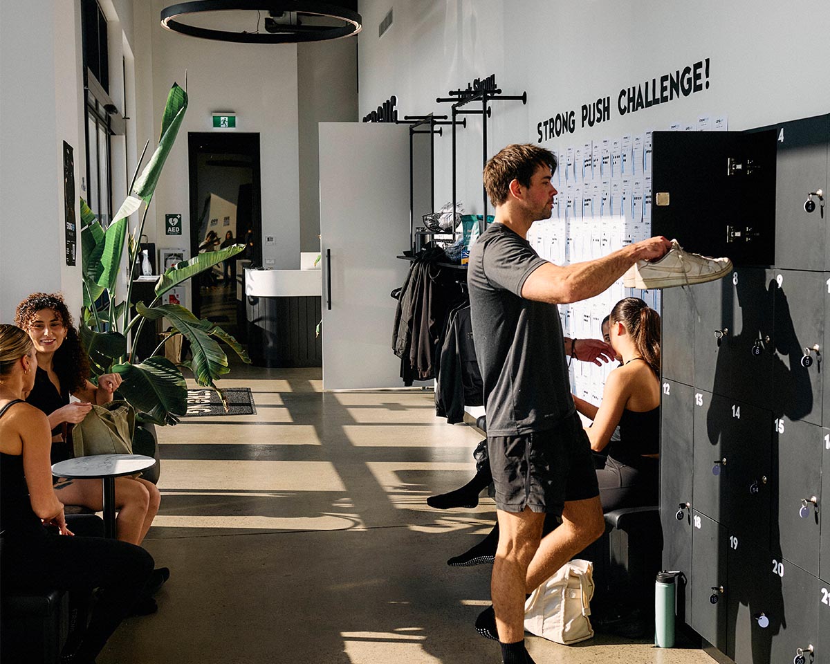 Members in a STRONG studio lobby by the lockers